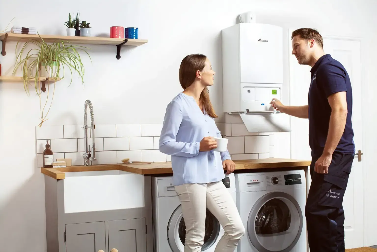 Worcester Bosch boiler installed in a London utility room with a homeowner and engineer